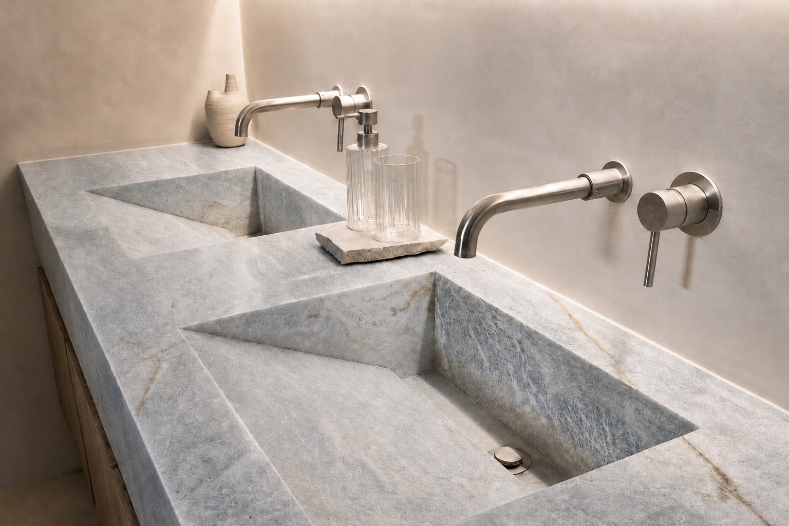 Natural stone double vanity with carved basins against hand-troweled microcement, by Taino Builds in Costa Rica's Southern Zone